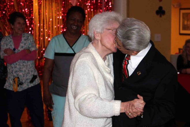 Married couple Sara and Nate Cordero-Cruz share a kiss on the dance floor after winning King and Queen at Brighter Living Assisted Living's King and Queen of Hearts Gala held in Hopewell on Thursday, Feb. 15. [Kelsey Reichenberg/progress-index.com]