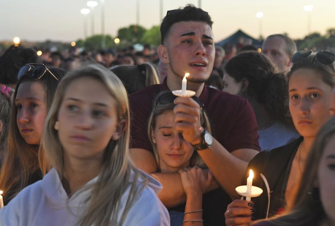 Mourners gather at a vigil that was held for the victims of the shooting at Marjory Stoneman Douglas High School on Thusday, Feb. 15, 2018, in Parkland. The teenager accused of using a semi-automatic rifle to kill more than a dozen people and injuring others at a high school confessed to carrying out one of the nation's deadliest school shootings and concealing extra ammunition in his backpack, according to a sheriff's department report released Thursday. [Jim Rassol/South Florida Sun-Sentinel]