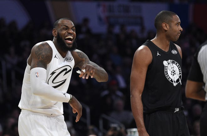 Team LeBron's LeBron James, left, of the Cleveland Cavaliers, laughs as Team Stephen's Al Horford, of the Boston Celtics, stands by during the second half of the NBA All-Star game Sunday in Los Angeles. [The Associated Press / Chris Pizzello]