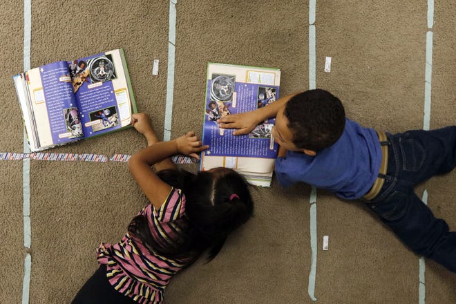 Jackeline Ventura and Anthony Silva work together on their reading work in class at the Hayden-McFadden School in New Bedford in this 2016 photo. [PETER PEREIRA/THE STANDARD-TIMES/SCMG]