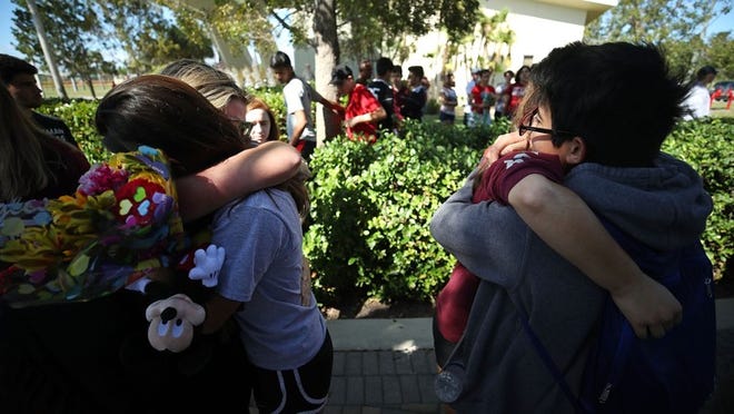 Students of Marjory Stoneman Douglas High School gather at Pine Trail Park in Parkland, Fla., on Feb. 15.