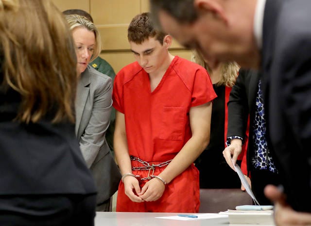 BOWED HEAD — Nikolas Cruz appears in court for a status hearing before Broward Circuit Judge Elizabeth Scherer on Monday. He faces 17 charges of premeditated murder in the mass shooting at Marjory Stoneman Douglas High School. (Mike Stocker/Sun Sentinel/TNS)