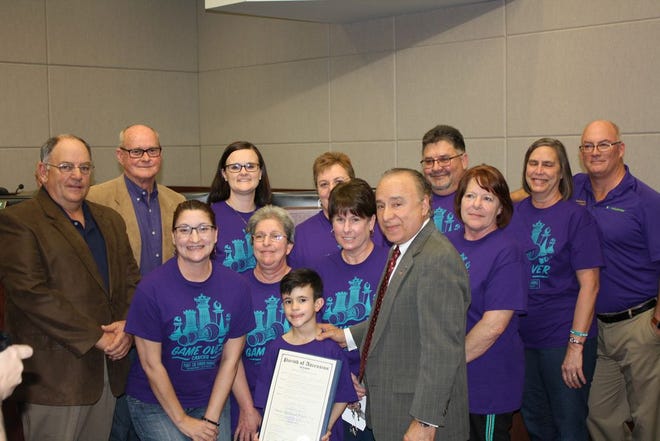 Front Row, Left to Right - Brock Dunnaway (holding proclamation) and President Matassa. Second Row, Left to Right - Kari Millet, Tracy Guillory, Kriste Haydel, and Alena White. Back Row, Left to Right – Councilmen Todd Lambert and Randy Clouatre, Tracey Anderson, Scottie Ward, Kim Myers, and Brian Janis.