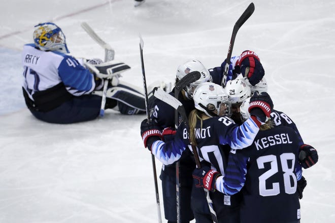 Players from the United States celebrate after Dani Cameranesi (24), of the United States, scores a goal against Finland in a 5-0 victory to advance to the gold medal game. [AP Photo/Julio Cortez]