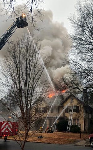 Firefighters work to extinguish the flames of a house fire on Monday, February 19, 2018. The house was built in 1917 and utilized a balloon frame, where studs extend for the entire height of the structure without fire stops on each floor. [Contributed photo/progress-index.com]