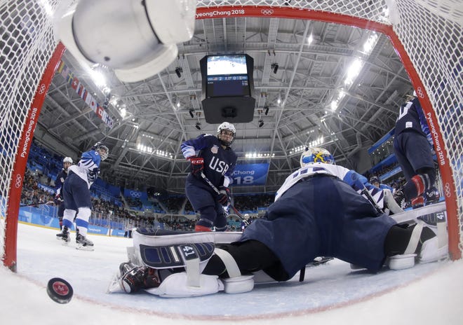 The puck shot by Jocelyne Lamoureux-Davidson, of the United States, sails past goalie Noora Raty (41), of Finland, during the second period of the semifinal round of the women's hockey game at the 2018 Winter Olympics in Gangneung, South Korea, Monday. [Matt Slocum/Pool Photo via AP]
