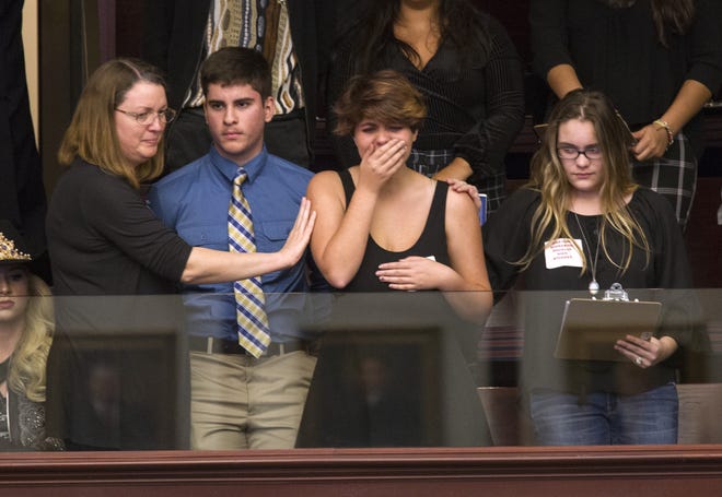 Sheryl Acquarola, a 16 year-old junior from Marjory Stoneman Douglas High School is overcome with emotion in the east gallery of the House of Representatives after the representatives voted Tuesday not to hear a bill banning assault rifles and large capacity magazines at the Florida Capital in Tallahassee. Acquarola was one of the survivors of the Marjory Stoneman Douglas High School shooting that left 17 dead. [AP Photo / Mark Wallheiser]