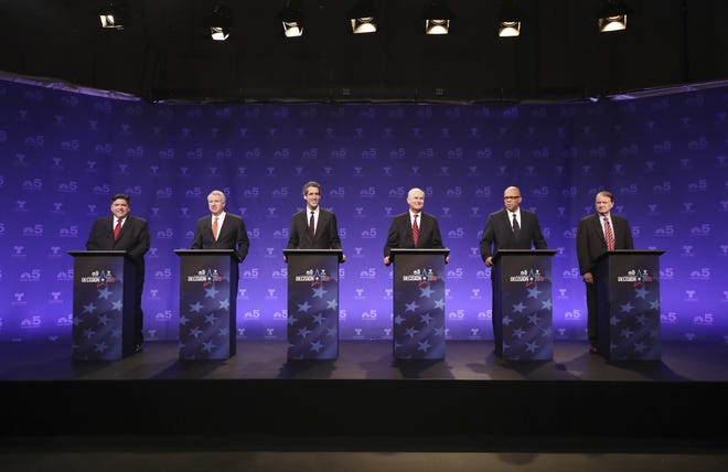 Democrats running for Illinois governor, from left, billionaire J.B. Pritzker, businessman Chris Kennedy, and state Sen. Daniel Biss, educator Robert Daiber, activist Tio Hardiman, and physician Robert Marshall take their podium positions before a televised forum Tuesday, Jan. 23, 2018, in Chicago. The six Democrats are vying for the chance to unseat Republican Gov. Bruce Rauner on March 20. (John J. Kim/Chicago Tribune via AP, Pool)