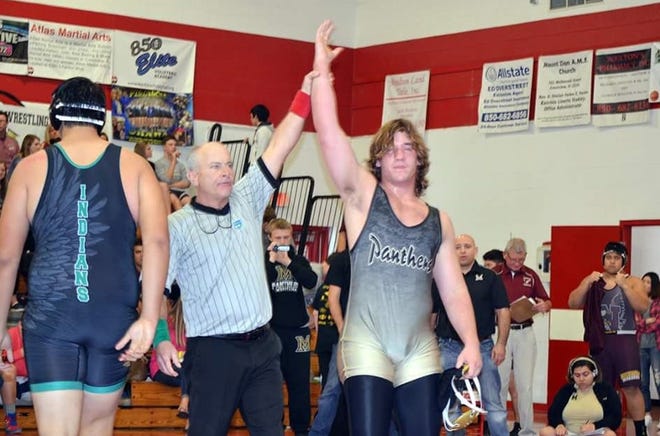 Milton High senior wrestler Connor Saint will advance to the regional meet in Tallahassee. [Photo by Jada Nicholson]
