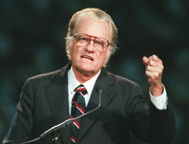 FILE - In this Oct 26, 1994 file photo, Evangelist Billy Graham begins his sermon in Atlanta's Georgia Dome.  Graham, who transformed American religious life through his preaching and activism, becoming a counselor to presidents and the most widely heard Christian evangelist in history, has died. Spokesman Mark DeMoss says Graham, who long suffered from cancer, pneumonia and other ailments, died at his home in North Carolina on Wednesday, Feb. 21, 2018. He was 99. (AP Photo/John Bazemore, File)