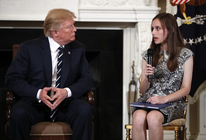 President Donald Trump listens to Carson Abt, a student at Marjory Stoneman Douglas High School in Parkland, as he hosts a listening session with high school students and teachers in the State Dining Room of the White House in Washington on Wednesday. (AP Photo/Carolyn Kaster)