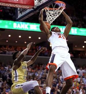 Virginia’s Nigel Johnson (23) dunks over Georgia Tech’s Moses Wright (12) during the second half of an NCAA college basketball game Wednesday in Charlottesville, Va. (Zack Wajsgras/The Daily Progress via AP)