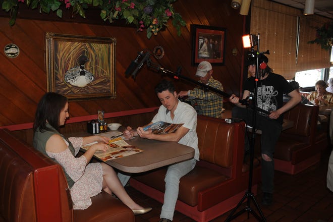 The crew of "Karaoke Knights" filming at Sterling Family Restaurant in Peoria last spring. Most of the filming for the independent movie occurred in Peoria and the film's debut will be at Landmark Cinemas on Feb. 28. Photo credit: Dean Williams Photography.