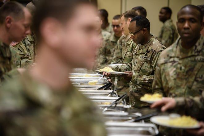 Soldiers fill their plates with food at the Fort Bragg Prayer Breakfast on Wednesday on Fort Bragg. [Andrew Craft/The Fayetteville Observer]