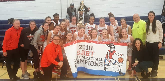 The Cherokee Chiefs pose with the South Jersey Invitational championship trophy and banner after beating Shawnee, 44-33, in the tournament final last Sunday. [NICK ITALIANO / STAFF PHOTOJOURNALIST]