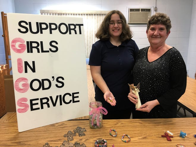 Girls in God's Service, a youth group at St. Paul's United Methodist Church, sold handmade ornaments and crafts made by African artisans to benefit children in impoverished communities. Gabrielle Irizarry, 14, is a member of the group, and Kathy Kovach oversees it. [DANIELLE DESISTO / STAFF PHOTOJOURNALIST]