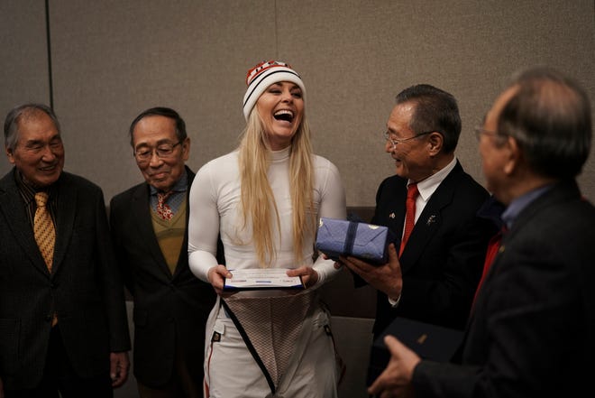 United States' Lindsey Vonn, center, smiles as she receives gifts and a letter of appreciation for her grandfather's service during the Korean War from members of the Yongsan Club in Jeongseon, South Korea, Thursday, Feb. 22, 2018. (AP Photo/Felipe Dana)