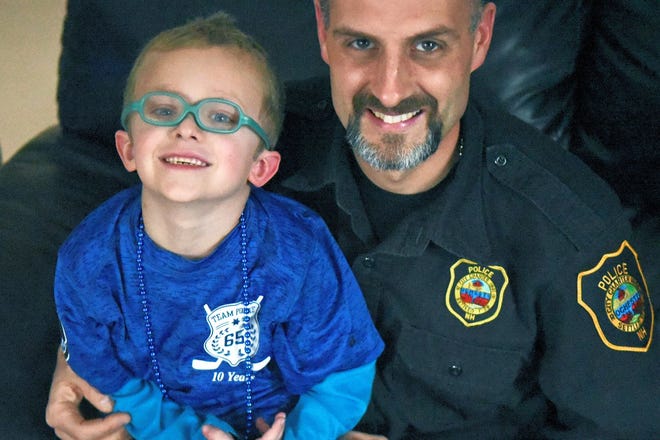Brycen Allen Berube, 6, of Somersworth and his Big Buddy, Rochester Police Officer Keith McKenzie are trying to raise money for CHaD (Children's Hospital at Dartmouth-Hitchcock.) McKenzie needs $1,500 to play in the Battle of the Badges Hockey Game on March 25. 
[Deb Cram/Fosters.com]