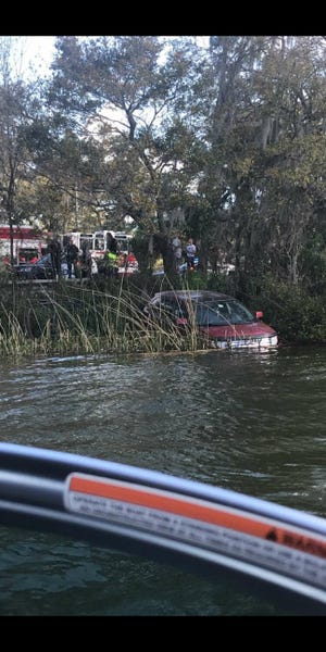 An SUV crashed through the roundabout at Hollingsworth Road and Lake Hollingsworth Drive and crashed into the lake Wednesday morning. [PHOTO COURTESY OF COLE MCCORMICK]
