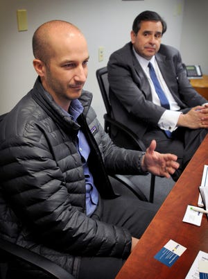 Greg Atkin (left), managing director of market development for SkyWest Airlines, and Gary Foss, managing partner of The ArkStar Group, talk during a news conference Thursday afternoon about air service from Salina. [TOM DORSEY / SALINA JOURNAL]