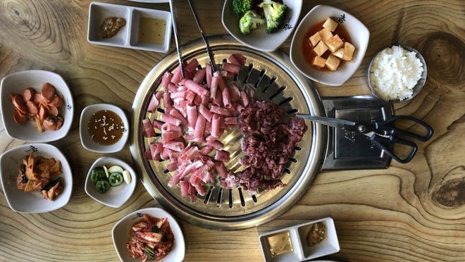 The meat at Charm Korean BBQ is delivered to the table to be grilled, along with an array of side dishes called banchan. Matthew Odam/AMERICAN-STATESMAN