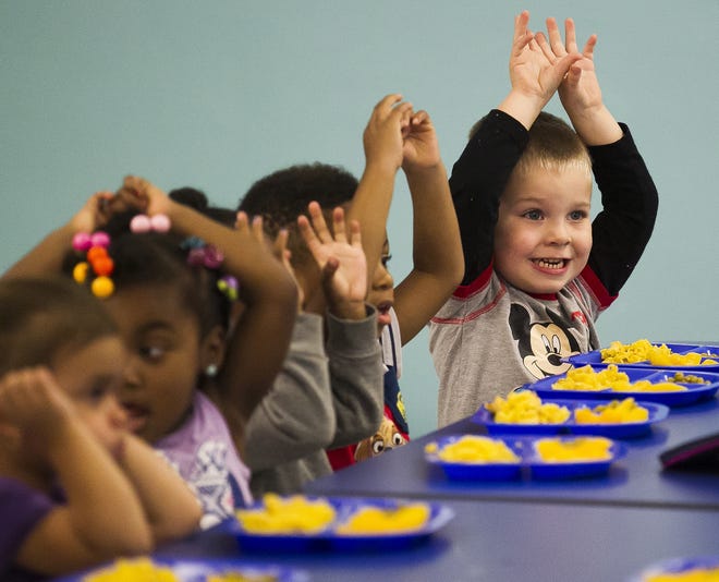Three-year-old Joshua Strickler, right, sings with classmates before eating their lunch Monday at All Stars Learning Center in Ocala. According to owner Karrissa Shannahan, 77 of the 150 children enrolled there are funded by the Early Learning Coalition's School Readiness Program. [Doug Engle Ocala-Star-Banner]