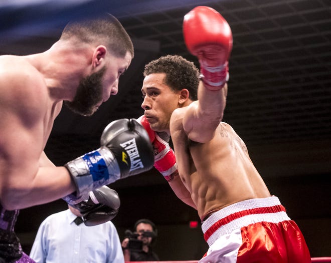 Ray Oliveira Jr. throws a left hook on Friday night at Twin Rivers Casino in a bout for the WBU Super Welterweight Championship. [RYAN FEENEY/STANDARD-TIMES SPECIAL/SCMG]