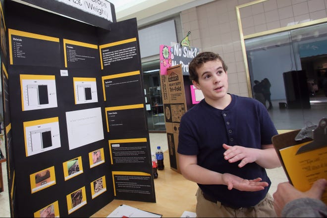 Van Buren student Ryan Wolf, 13, talks about his science fair project on the effects of cover crops have on soybean weight during the Science Fair last February at Westland Mall in West Burlington. The 2018 Science Fair is Thursday at the mall. [file/thehawkeye.com]