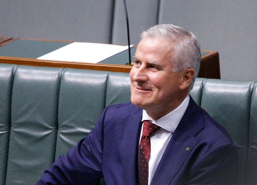 Australian Nationals party leader and Deputy Prime Minister, Michael McCormack, smiles while sitting in parliament in Canberra, Monday, Feb. 26, 2018. McCormack was appointed after his predecessor quit over a sexual harassment allegation. (AP Photo/Rod McGuirk)