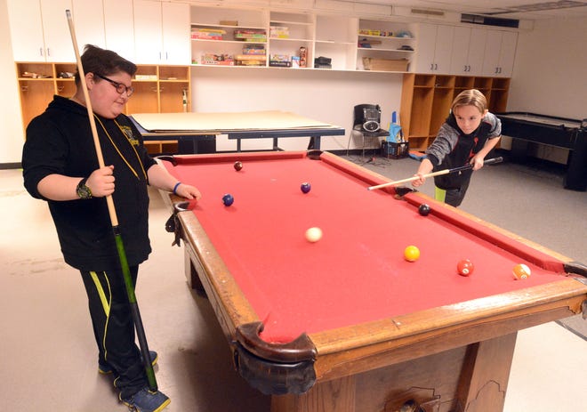 Gabriel Doud, 12, watches as Owen Tracy, 12, lines up his shot during a game of pool at the Brooklyn Teen Center.

[Aaron Flaum/NorwichBulletin.com]