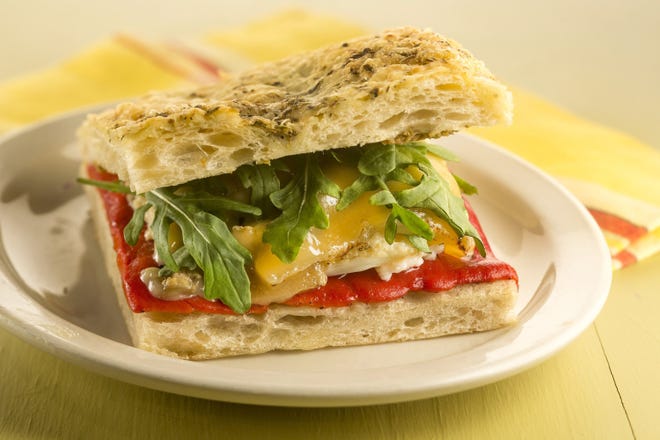 This twist on a pepper and egg sandwich has all the elements of the traditional version, but also adds olive tapenade, cheese and fresh arugula. (Bill Hogan/Chicago Tribune/TNS)