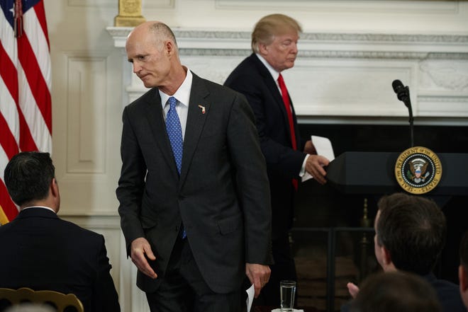 Gov. Rick Scott, R-Fla., walks off after speaking about school safety during a meeting with President Donald Trump and members of the National Governors Association in the State Dining Room of the White House, Monday, Feb. 26, 2018, in Washington. (AP Photo/Evan Vucci)