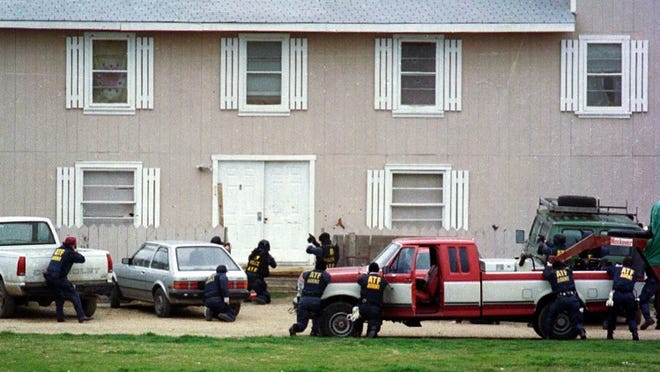 Federal Alcohol Tobacco and Firearms agents approach the front door of the Branch Davidian Compound near Waco on Feb. 28, 1993, in an attempt to serve a search warrant. (Photo by Rod Aydelotte/Waco Tribune Herald)