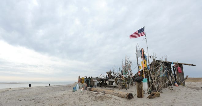 The flag at the beach shack south of Lighthouse Beach waves in the light breeze Monday morning.
