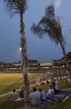 In this 2003 photo, Peoria Chiefs fans under the palm trees enjoy the last game of the season.