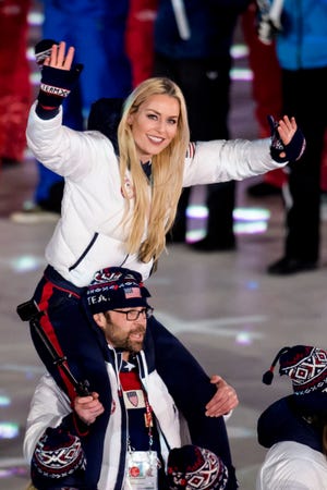 Lindsey Vonn, of the United States, is carried on the shoulders of her teammate Nick Baumgartner into the stadium during the closing ceremony of the 2018 Winter Olympics in Pyeongchang, South Korea, Sunday, Feb. 25, 2018. (Jean-Christophe Bott/Keystone via AP)