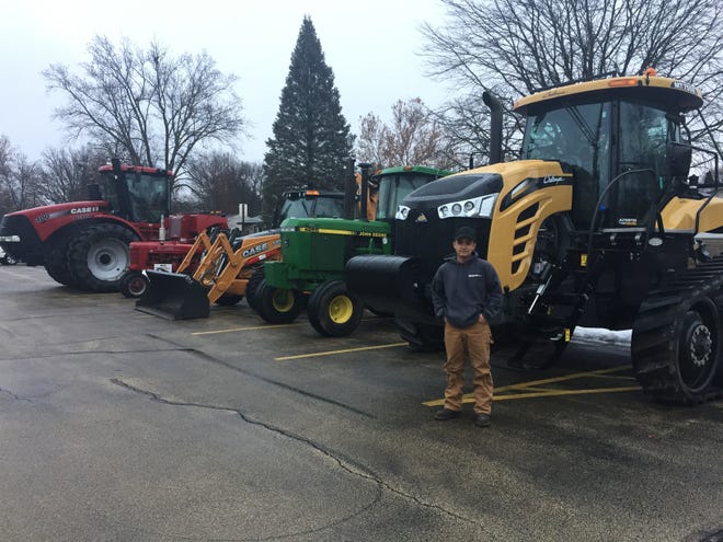 West Carroll FFA Week recently was held at the West Carroll School District. Pictured: Julian Ortiz stands in front of the Neumiller Farms Cat Challenger that he drove to school for Tractor Day. [PHOTO PROVIDED]