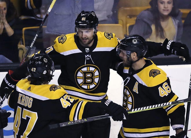 Bruins left wing Rick Nash (center) celebrates with defenseman Torey Krug (left) and center David Krejci after scoring his first goal since being traded to Boston in the second period of the B's 4-3 overtime win over the Hurricanes on Tuesday night.