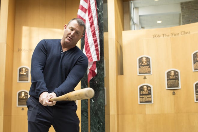 Former Cleveland Indians and Chicago White Sox slugger Jim Thome demonstrates his swing in the Plaque Gallery during his orientation tour of the National Baseball Hall of Fame and Museum, Tuesday, Feb. 27, 2018, in Cooperstown, N.Y., to prepare for his induction this summer. [MILO STEWART JR/NATIONAL BASEBALL HALL OF FAME AND MUSEUM VIA AP]