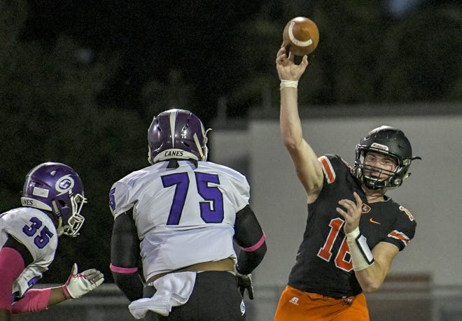 Leesburg's Wyatt Rector (16) passes under pressure against Gainesville High School in Leesburg on Oct. 20, 2017. Rector was named to the Class 6A All-State first team as an athlete. [PAUL RYAN / CORRESPONDENT]
