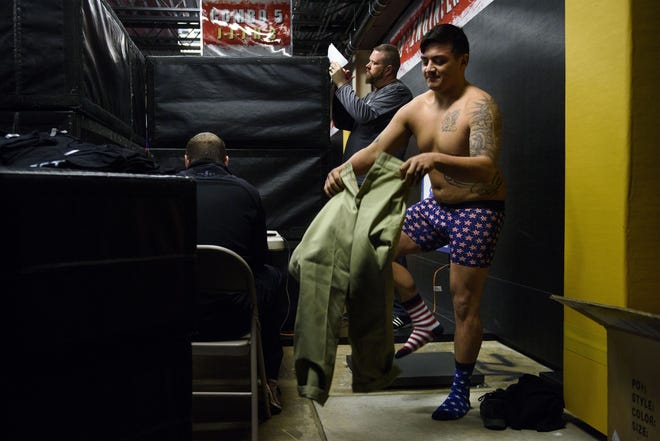 Spc. Alex Nuanez from Fort Campbell, Ky., redresses Wednesday after a weigh-in ahead of this week's Fort Bragg Combatives Tournament Invitational. The tournament is the largest of its kind in the military and a de facto Army championship. [Melissa Sue Gerrits/The Fayetteville Observer]