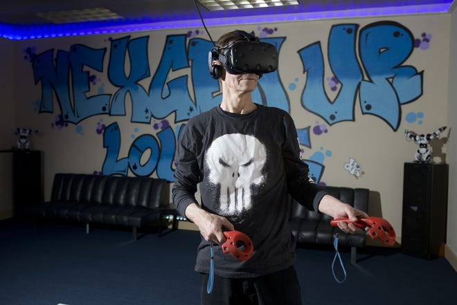 Richard Stephens, owner of NexGen VR, demonstrates his virtual reality arcade games Tuesday. [JOSHUA BOUCHER/THE NEWS HERALD]