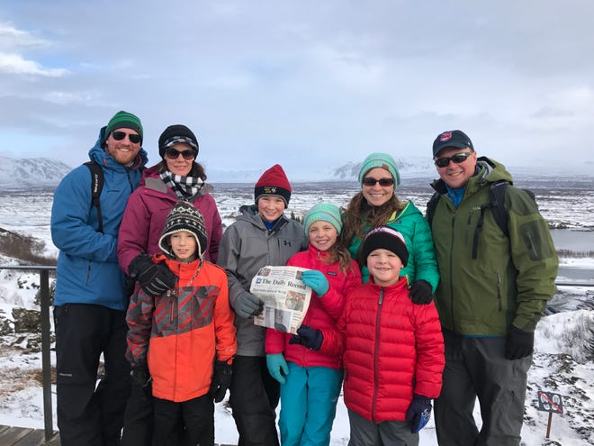 Eric, Bronwyn, Liam and Grayson Lingenfelter of Lititz, Pa (originally of Holmesville) with John, Susan, Brooklyn and Jack Bowling of Wooster pose with The Daily Record at Pingvellir National Park, Iceland.