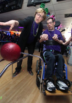 Stella Bommarito lends help to Greg during the 25th Angel Bowl to raise money for Holy Angels. This year's Angel Bowl takes place March 3 at George Pappas Liberty Lanes. [MIKE HENSDILL/THE GAZETTE]