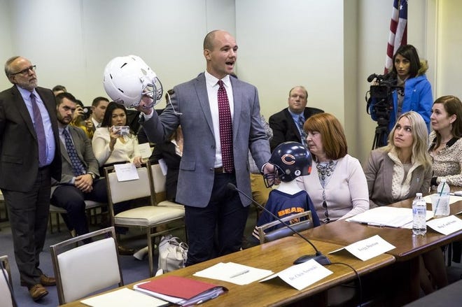 Chris Borland, a former NFL linebacker and Big Ten Defensive Player of the Year for the University of Wisconsin, testifies Thursday at the Stratton Building before the Illinois House mental health committee hearing on House Bill 4341, which would ban tackle football for children younger than 12. Borland was illustrating how repetitive sub-concussive hits that begin when children play impact sports can be as dangerous as a single hit that results in a concussion. (Rich Saal/GateHouse Media Illinois)
