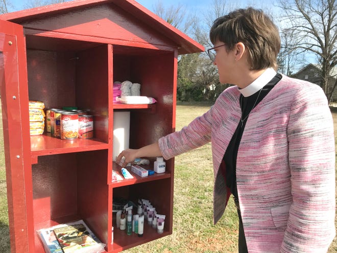 Pastor Christina Auch looks at items in the Little Free Pantry near Ascension Lutheran Church in Shelby. [Wade Allen/The Shelby Star]