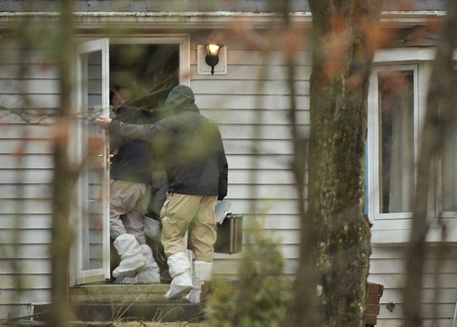 On Friday morning, state police investigators enter the home on Old Warren Road. [T&G Staff/Rick Cinclair]