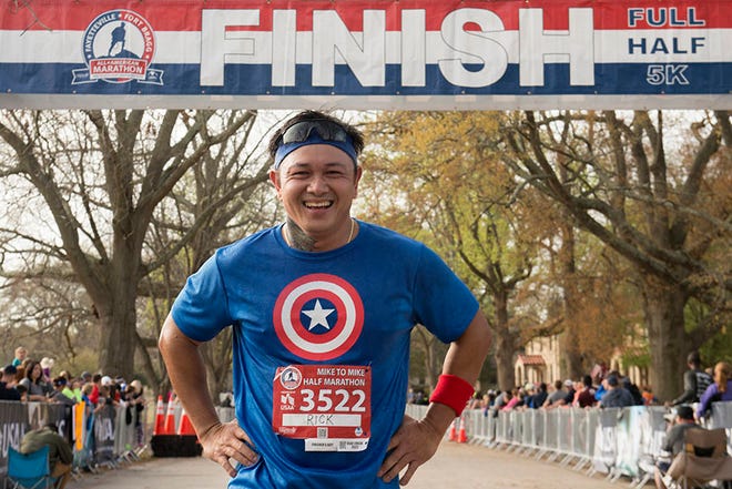 Ricardo Garcia smiles as he crosses the finish line of the Mike-to-Mike Half Marathon at the Main Post Parade Field, March, 2017. The half marathon is part of the All-American Marathon event. The race begins in downtown Fayetteville and ends near the Iron Mike statue at Fort Bragg. This year’s All American Marathon event is on March 25.