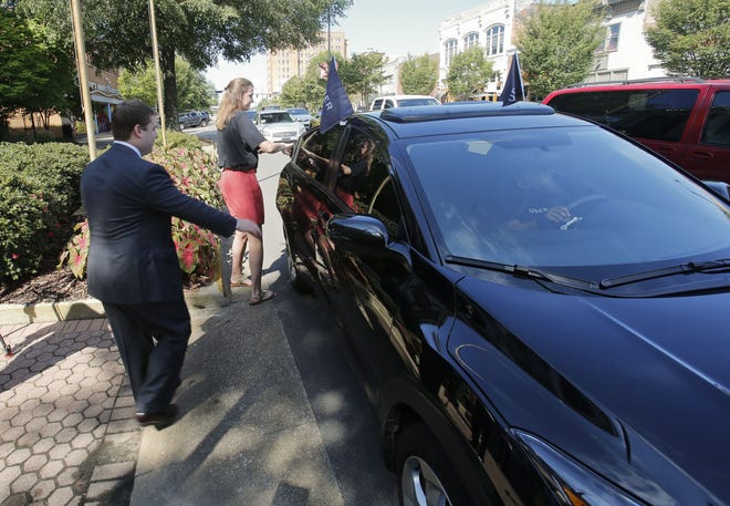 City Councilman Matt Calderone and University of Alabama SGA President Lillian Roth get in the car for the first Uber ride in Tuscaloosa on Aug. 18, 2016. [Staff file photo/Gary Cosby Jr.]