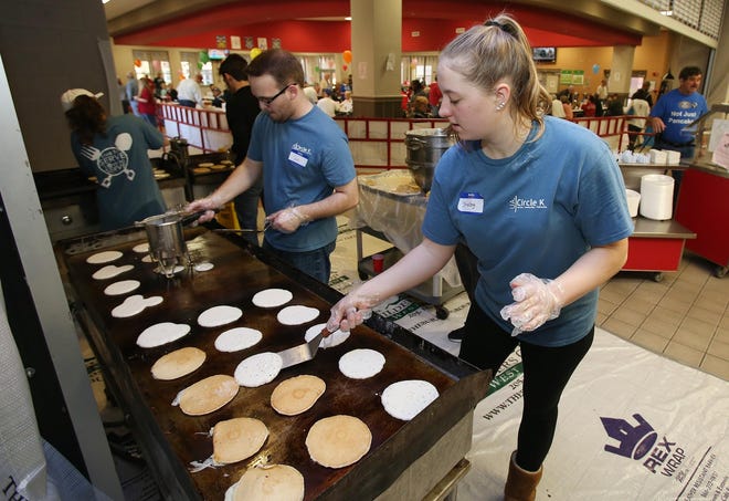 Shelby Dirkschneider, right, and Jim Bosley make dozens of pancakes on a griddle during the Kiwanis Pancake Day held at the Central High School cafeteria in Tuscaloosa, Ala. on Saturday March 5, 2016. Members from the local Tuscaloosa Kiwanis Club, the University of Alabama Circle K, and local high school Key Clubs worked the event to raise money for local charities. staff photo/Erin Nelson